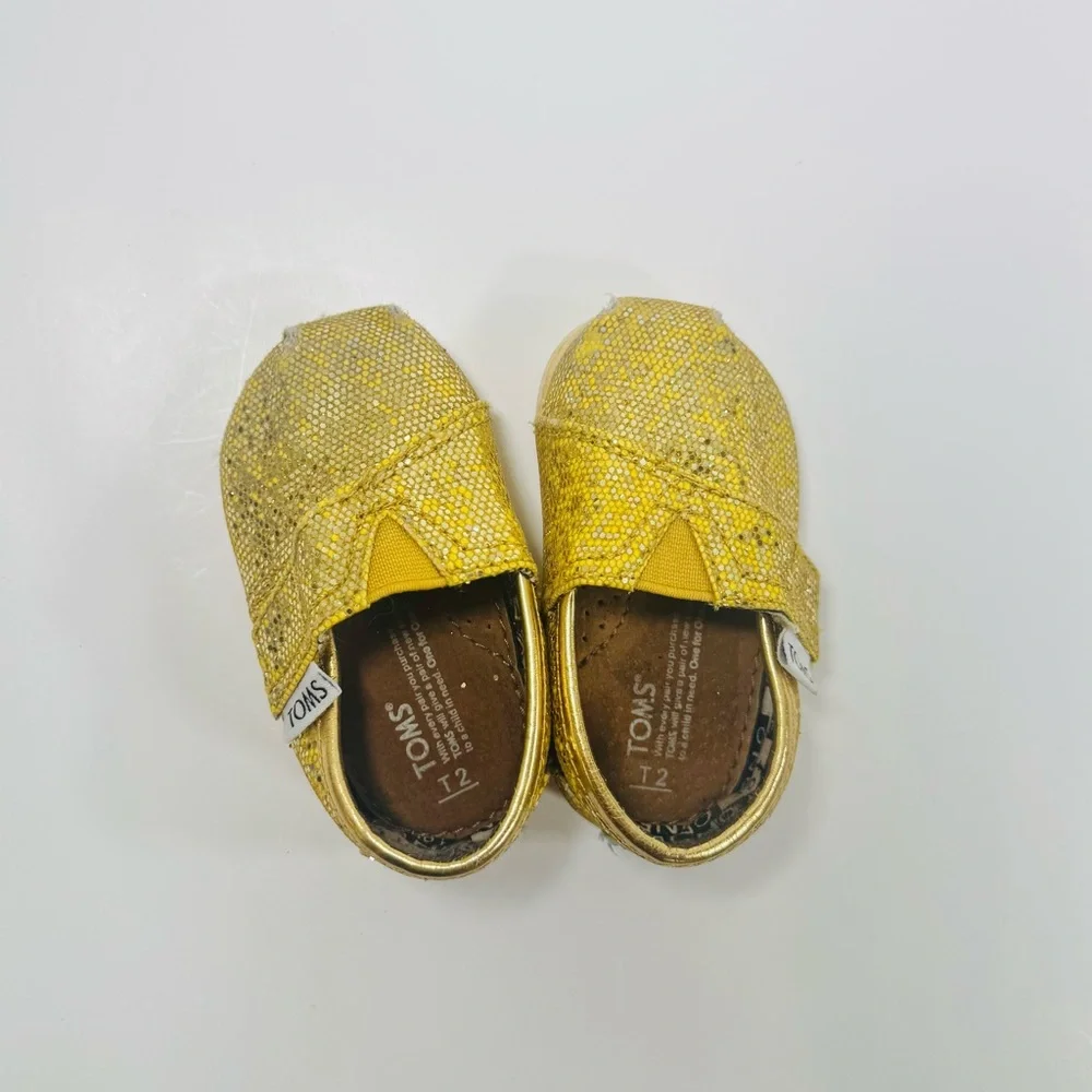 TOMS 2T Yellow Gold Sparkly Toddler Shoes with Velcro Strap.